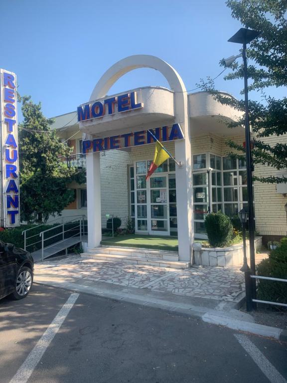 a hotel with a sign on the front of it at Motel Prietenia in Giurgiu