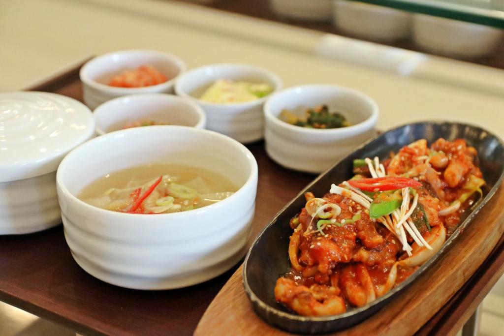 - un plateau avec une assiette de nourriture et des bols de nourriture dans l'établissement Holiday Inn & Suites Alpensia Pyeongchang Suites, an IHG Hotel, à Pyeongchang