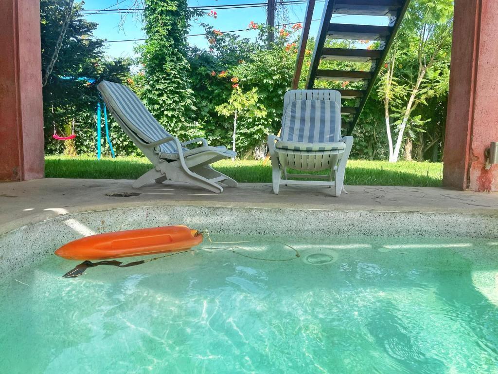 a toy boat and a chair in a swimming pool at Villa Revita Kourouta beach in Kourouta