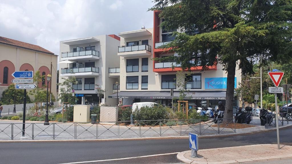 a building on a city street with a street sign at COTE VILLAGE in Nice