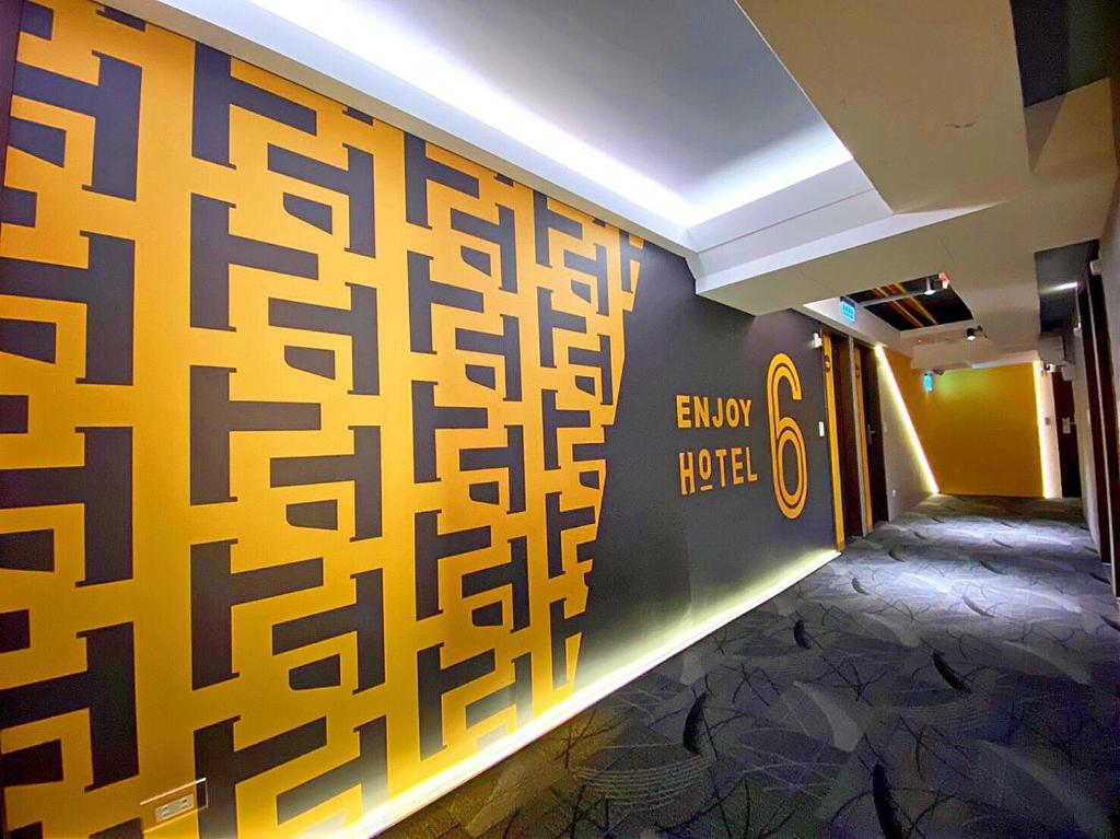 a hallway with a mural of a chinese writing on the wall at Hotel 6 - Ximen in Taipei