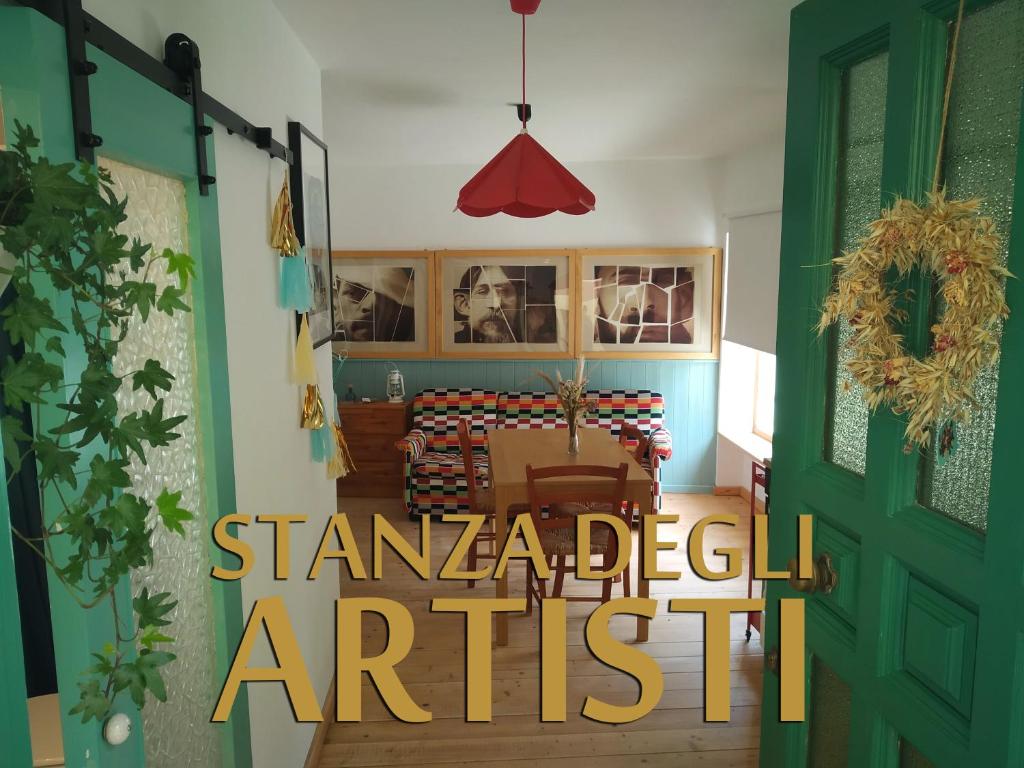 ein Wohnzimmer mit einer grünen Tür mit den Worten eines Rebellen-Künstlers in der Unterkunft La finestra sul cortile in Atri
