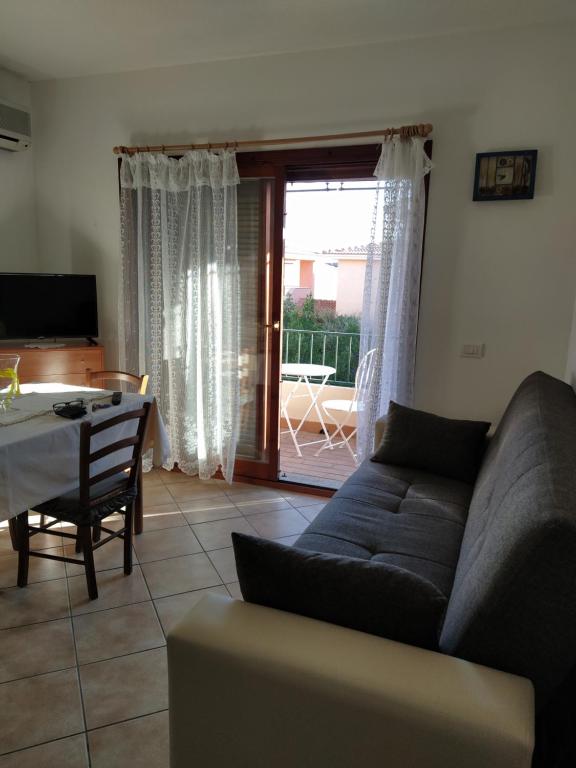 a living room with a couch and a table at LA CALA in Olbia