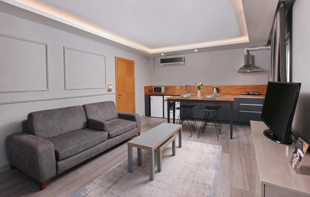 a living room with a couch and a kitchen at Family Time Suites Hotel in Istanbul