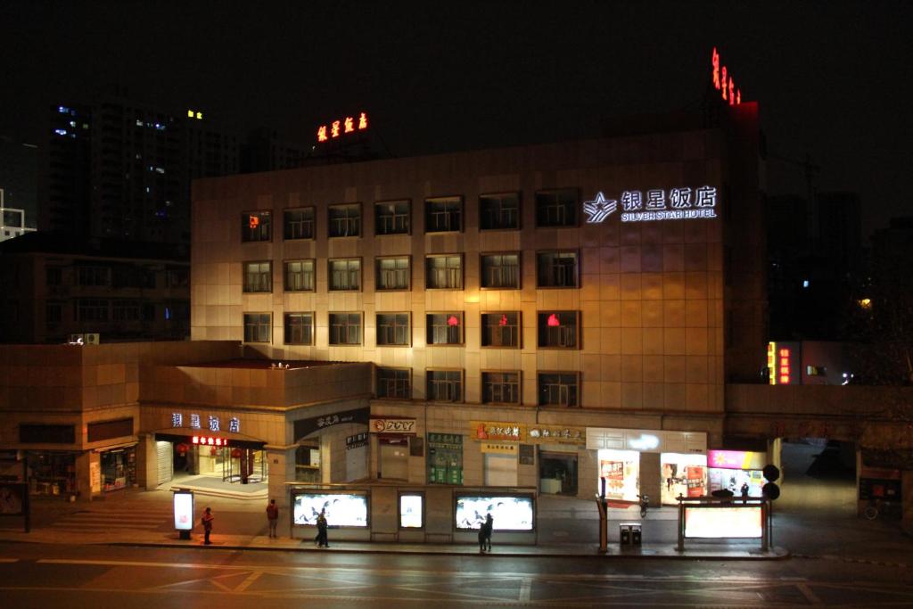 a building with a sign on top of it at night at Hangzhou Yinxing Hotel in Hangzhou