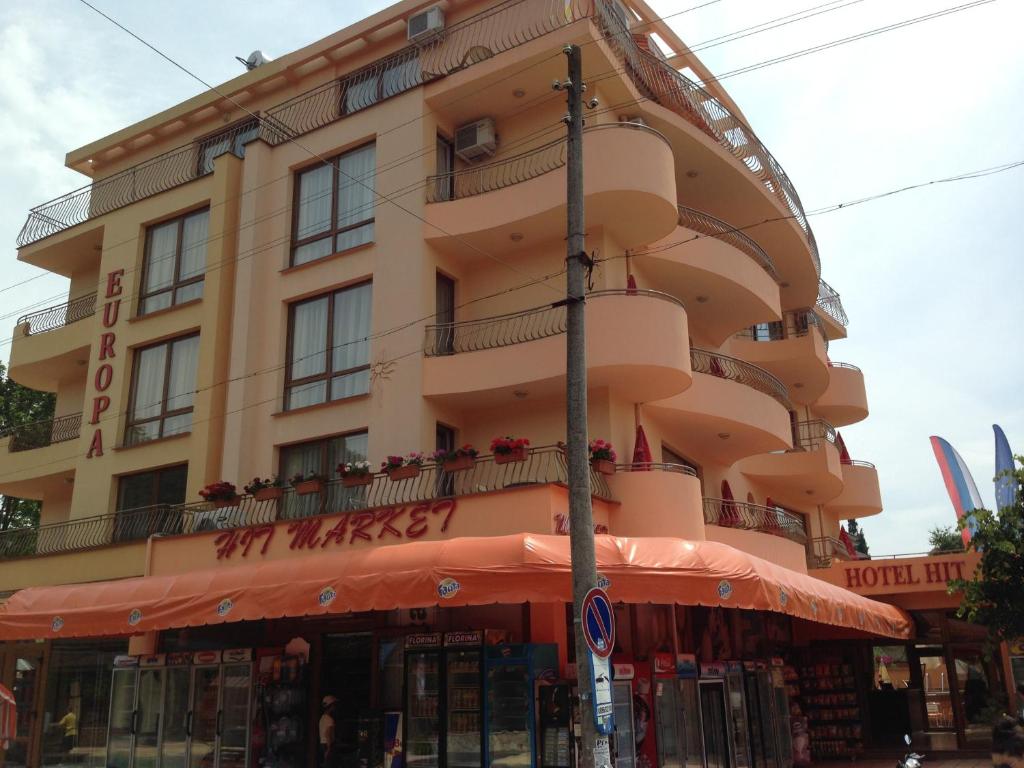 a large building with a store in front of it at Hotel Hit in Kiten