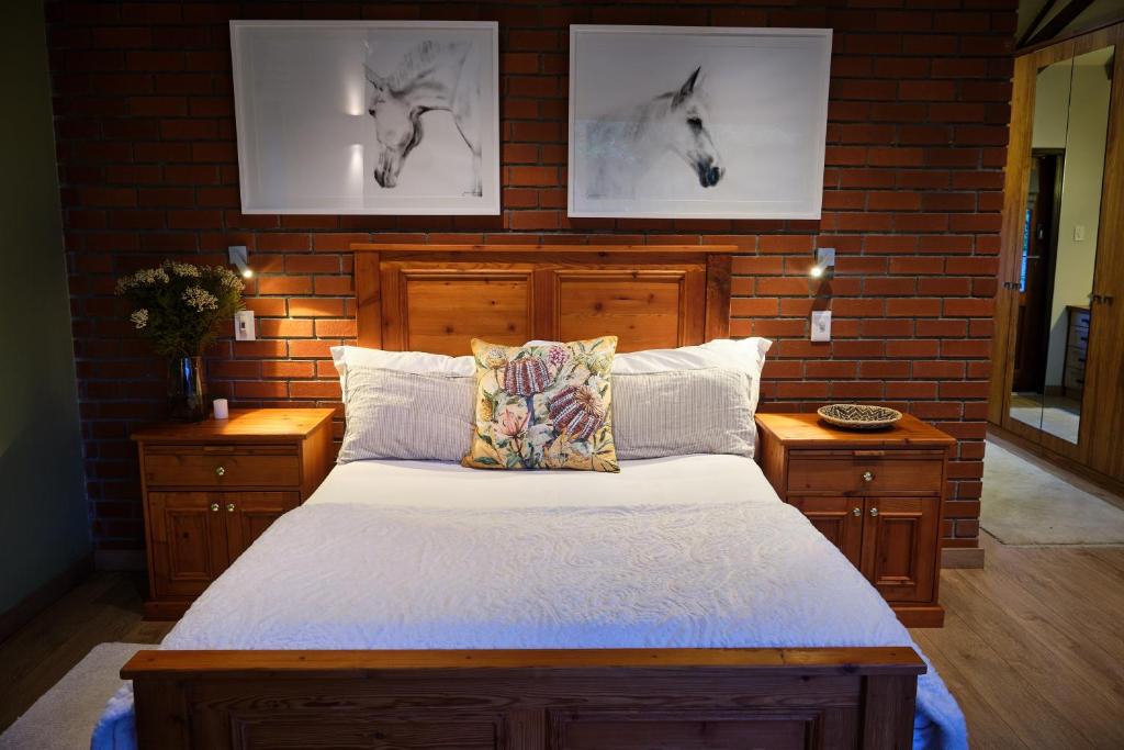 1 dormitorio con 1 cama y 2 fotografías de caballos en la pared en The Cottage Farm en Stellenbosch