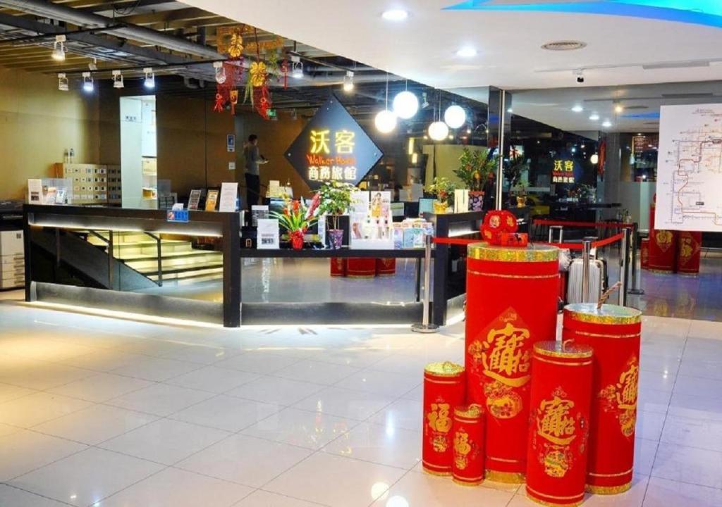 a store with red barriers in the middle of a building at Walker Hotel - Sanchong in Taipei