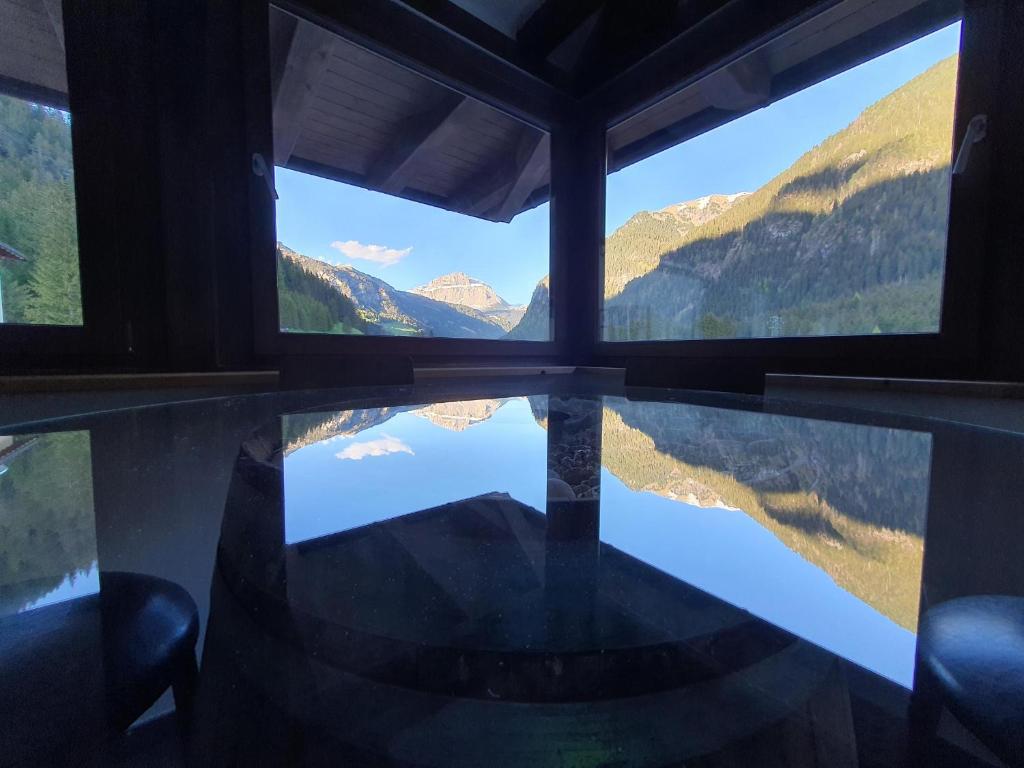 a view out a window of a boat with mountains at Soggiorno Dolomiti in Mazzin