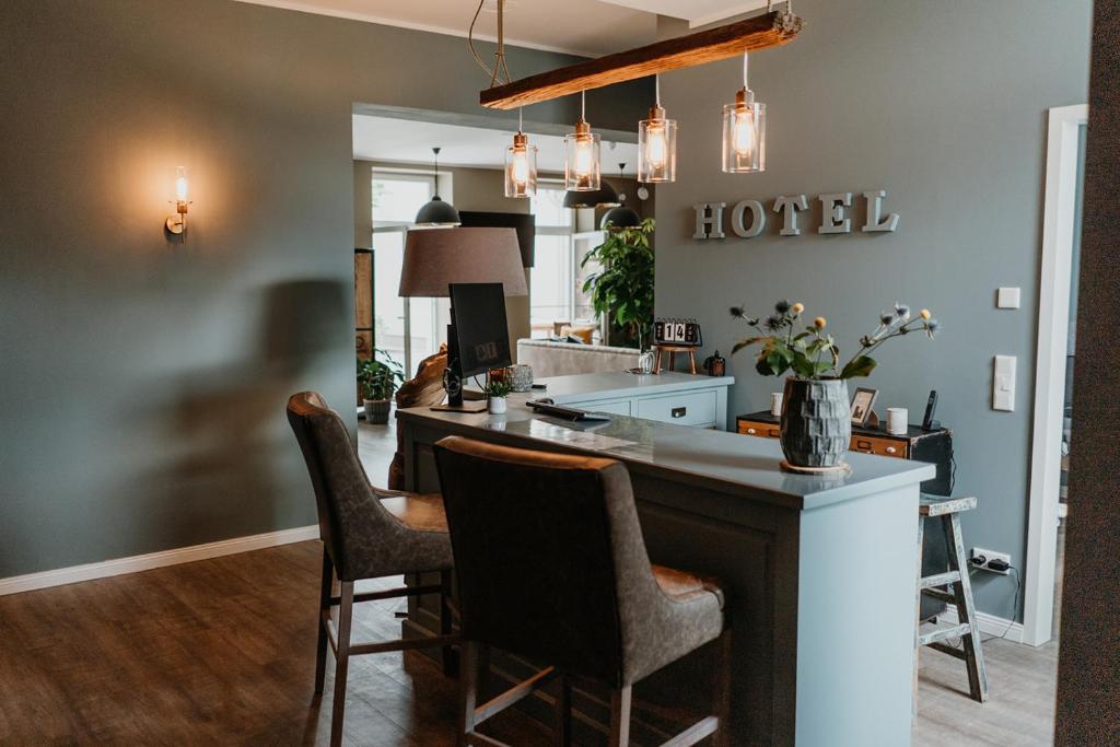 a kitchen with a large island in a living room at HÖNOW HOTEL in Hoppegarten