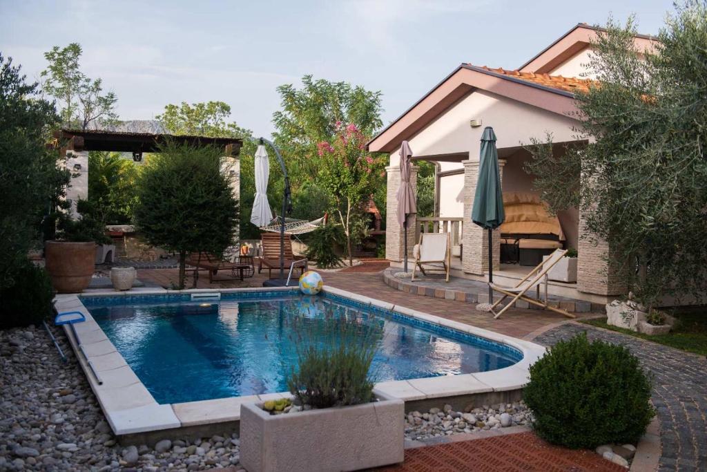 a swimming pool in the yard of a house at Villa Aleksandra in Ljubuški