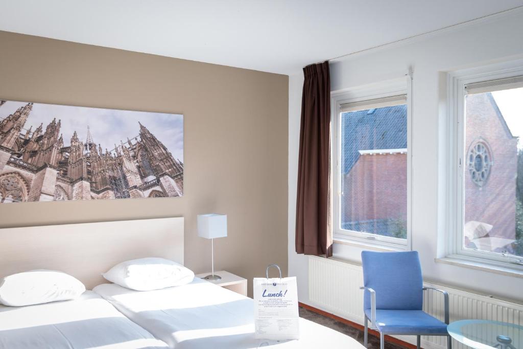 Postel nebo postele na pokoji v ubytování Fletcher Kloosterhotel Willibrordhaeghe