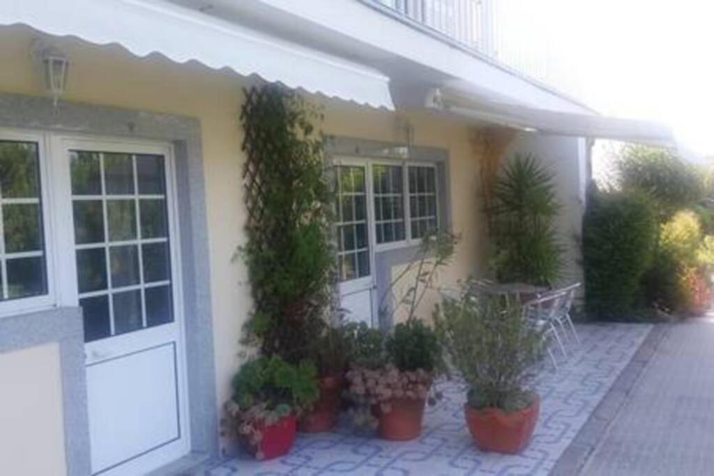 a house with potted plants in front of a door at studio Mira in Abragão