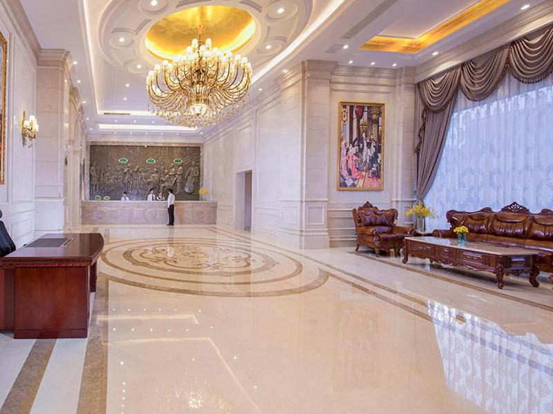 un grand hall avec un lustre et une grande salle dans l'établissement Vienna International Hotel Guangzhou Changlong Qifu Xincun, à Canton