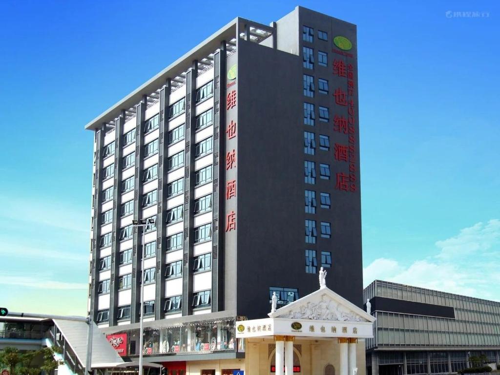 a large black building with a cross in front of it at Vienna Hotel Longgang Nanlian in Longgang