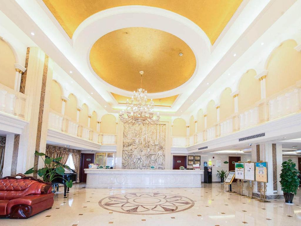 a large lobby with a chandelier in a building at Vienna Hotel Shanghai Hongqiao Airport Center in Shanghai