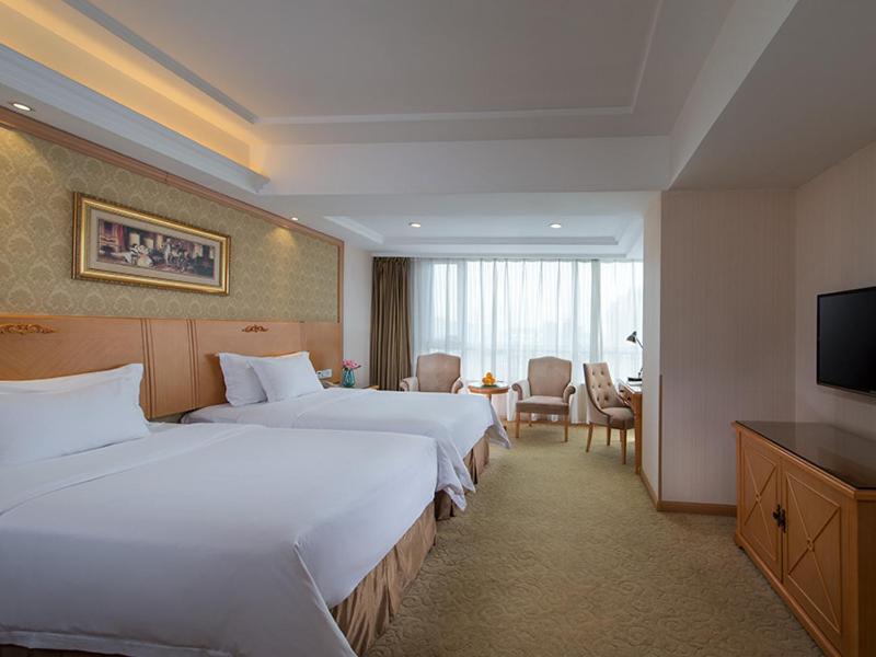 a hotel room with two beds and a television at Vienna International Hotel Shenyang Railway Station in Shenyang