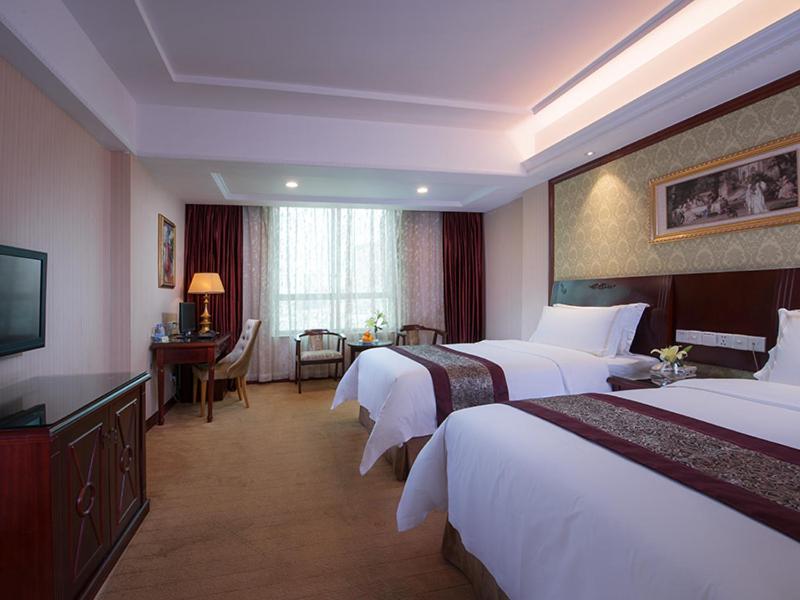 Postel nebo postele na pokoji v ubytování Vienna Hotel Shanwei Haifeng