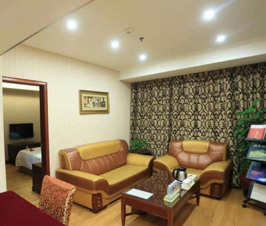 a living room with a couch and a table at Vienna Hotel in Pinghu Square in Longgang