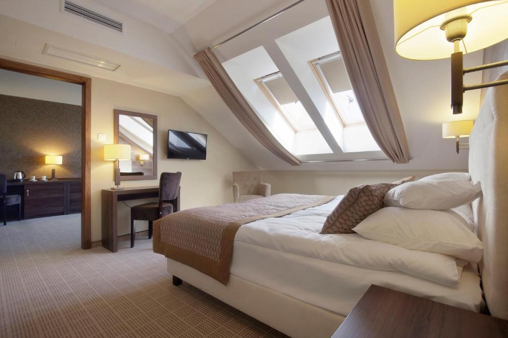 Postel nebo postele na pokoji v ubytování Tristan Hotel & SPA