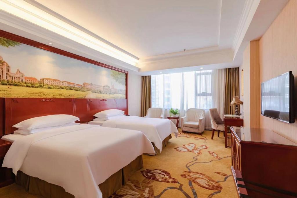 Postel nebo postele na pokoji v ubytování Vienna Hotel Shenzhen Bao'an Xin'an