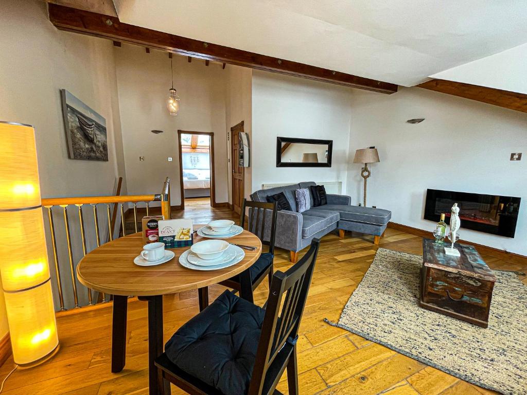 a living room with a table and a couch at Harbourside Apartments in Portpatrick