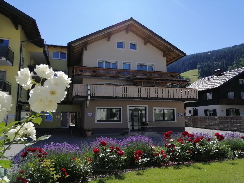 a house with flowers in front of it at Appartements Frauenschuh in Schladming