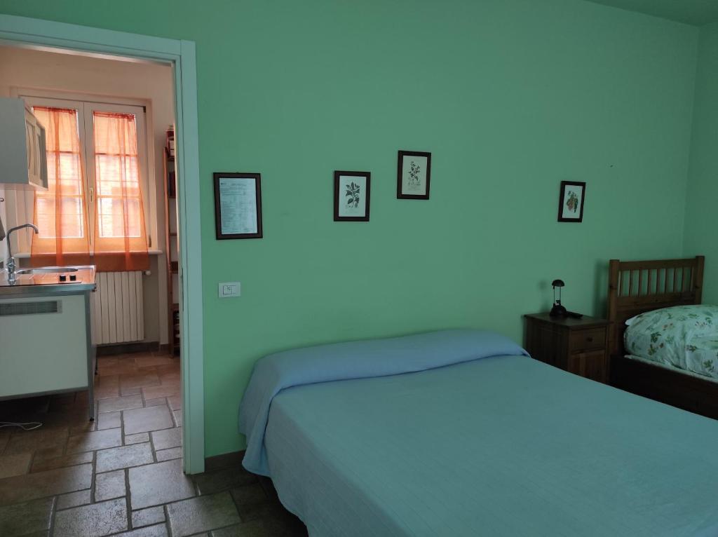 a bedroom with a bed and a kitchen with a sink at Agriturismo Vignarello in Tornaco