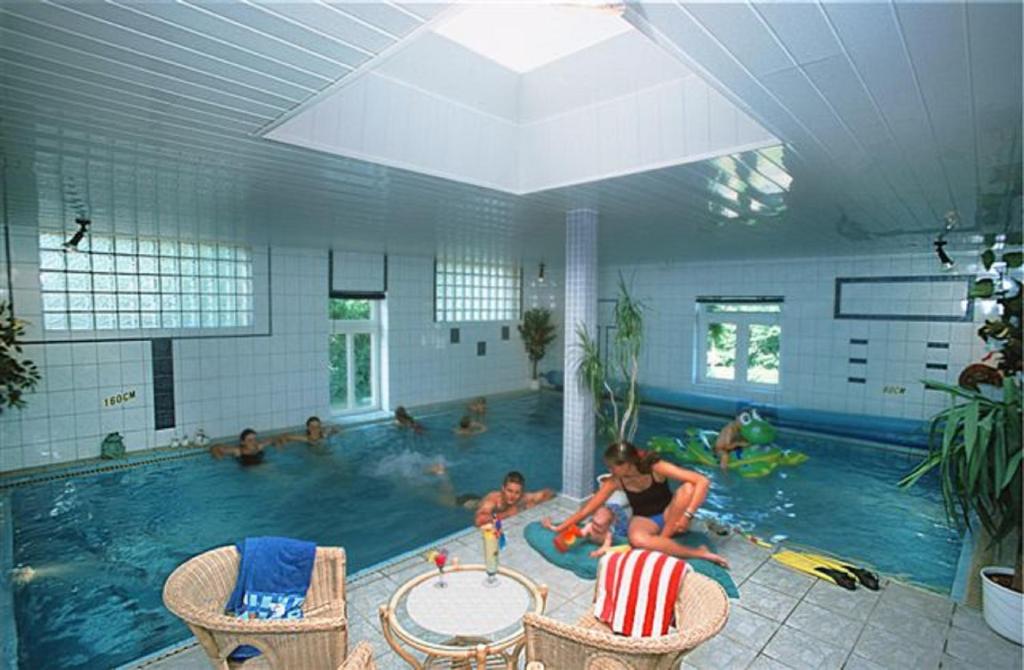 a group of people in a swimming pool at Hof Schlossblick in Bösdorf