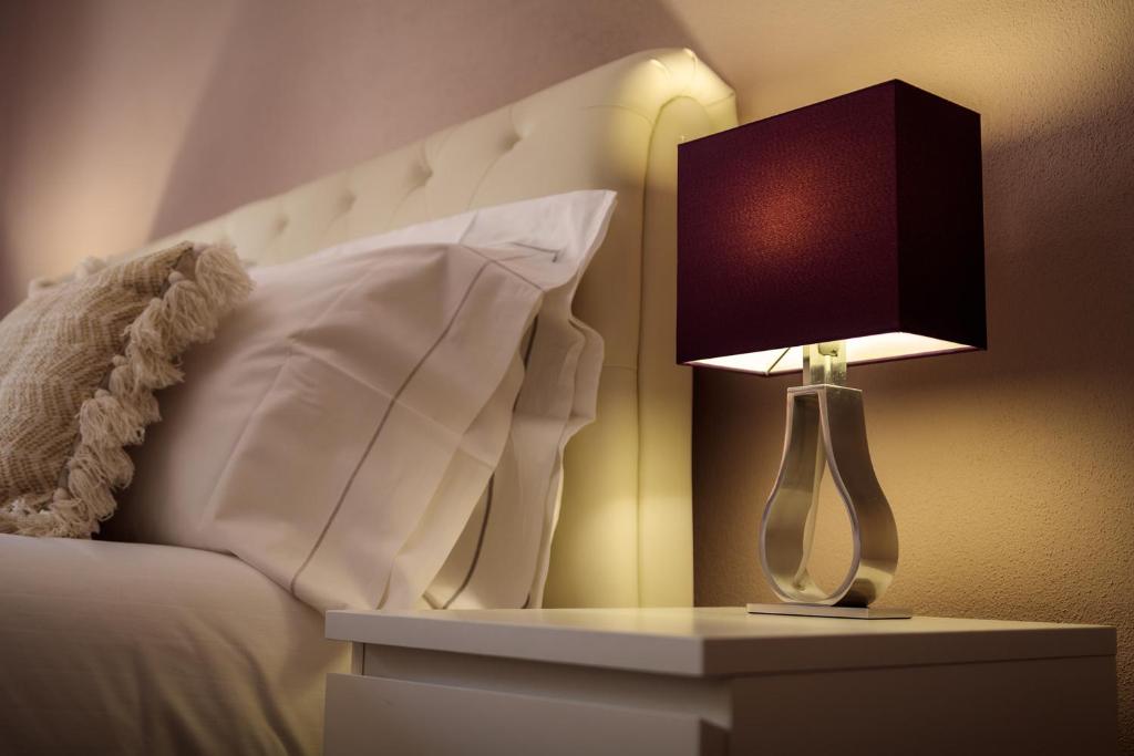 Postel nebo postele na pokoji v ubytování Arcobaleno Suites