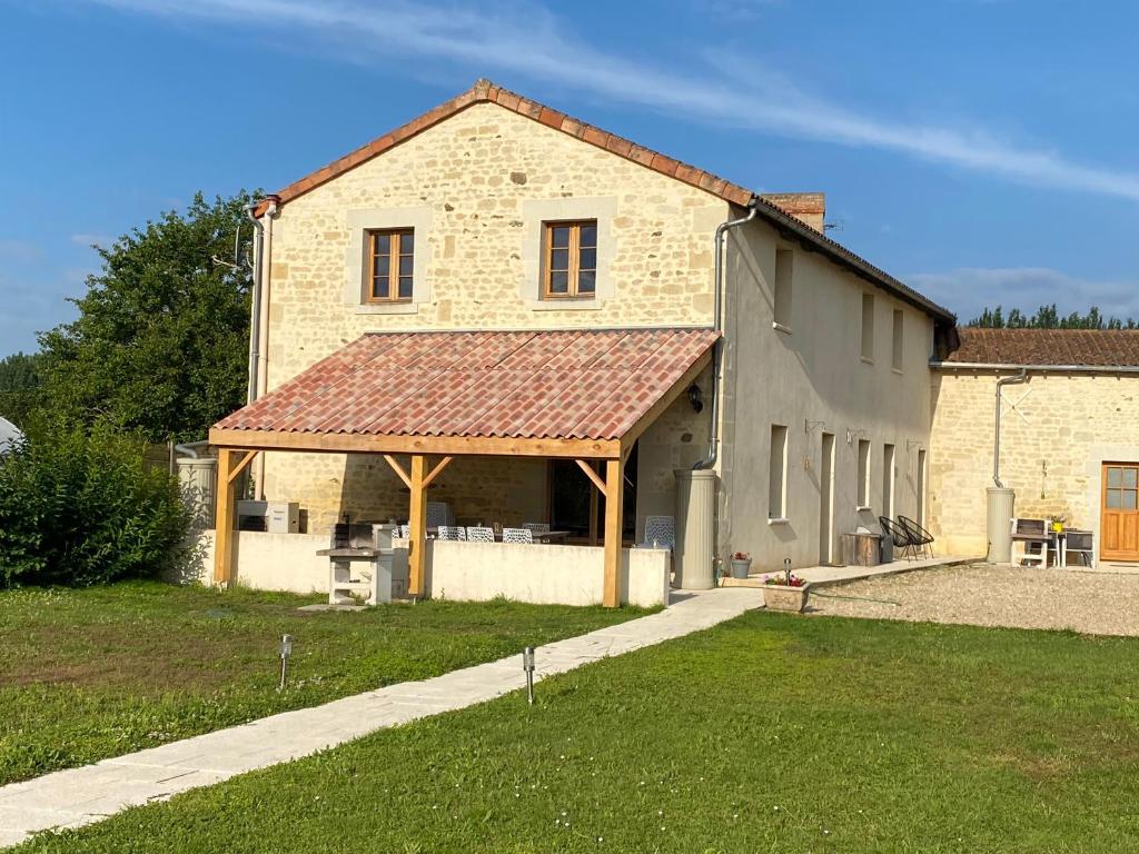 a large brick building with a red roof at Loire Escapes - Maison D'Hibou in Berrie