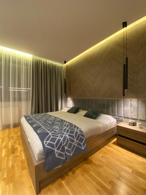 a bedroom with a large bed in a room at DOM Boutique Apartments - Park View in Belgrade