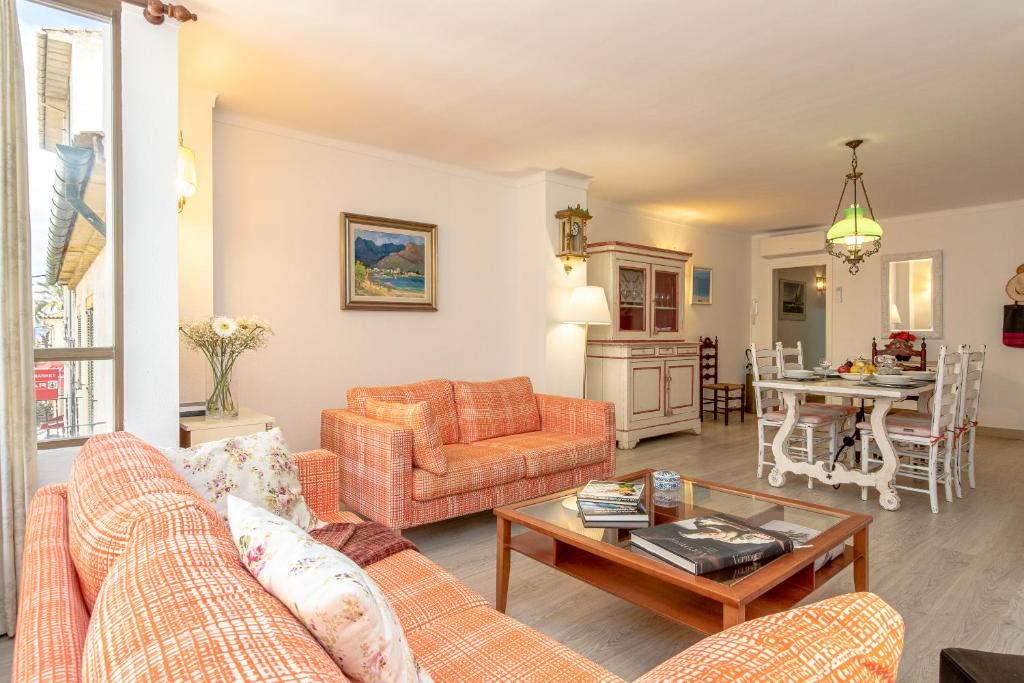 a living room with a couch and a table at Apartment Almirall in Puerto Pollensa By homevillas360 in Pollença