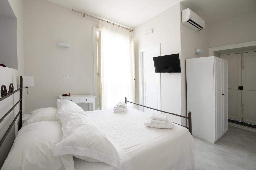 Posteľ alebo postele v izbe v ubytovaní EFFE SUITES