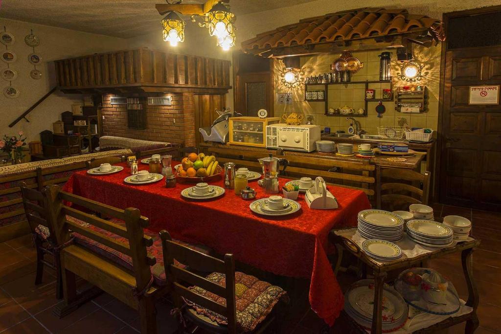 a kitchen with a table with plates and fruit on it at B&B IL GERLO in Casargo