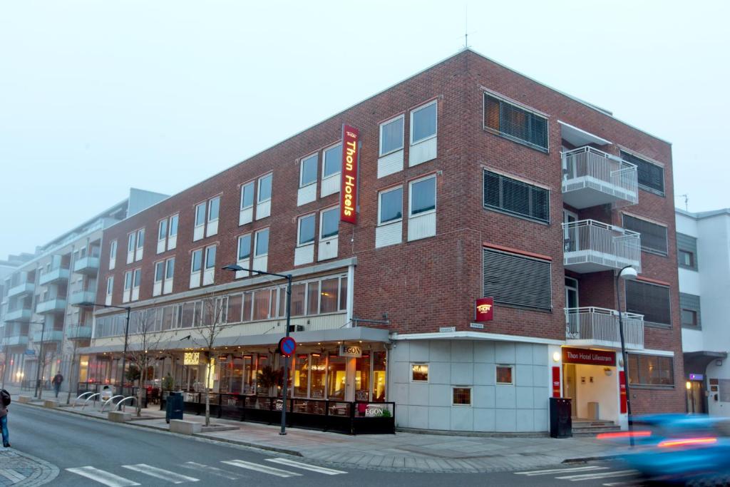 a large brick building on a city street at Thon Hotel Lillestrøm in Lillestrøm