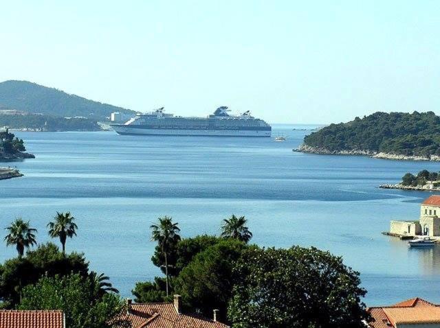 a large cruise ship in a large body of water at Apartments Radis in Zaton