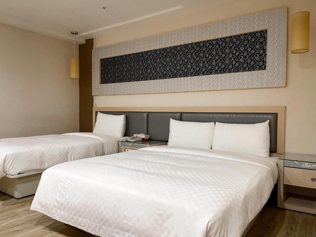 Postel nebo postele na pokoji v ubytování Beidoo Hotel