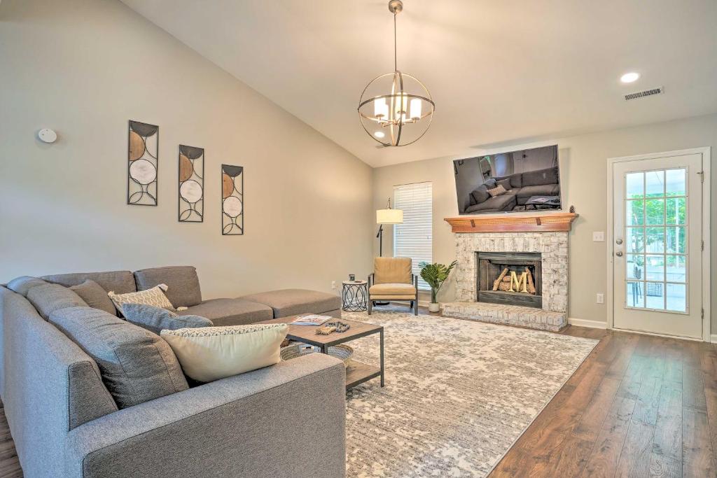 a living room with a couch and a fireplace at Modern Retreat - 4 Miles to Isle of Palms Beach! in Charleston