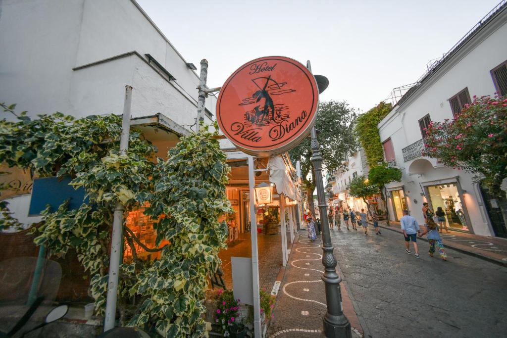 a sign for a shop on a city street at Villa Diana - Beach & Rooms in Ischia