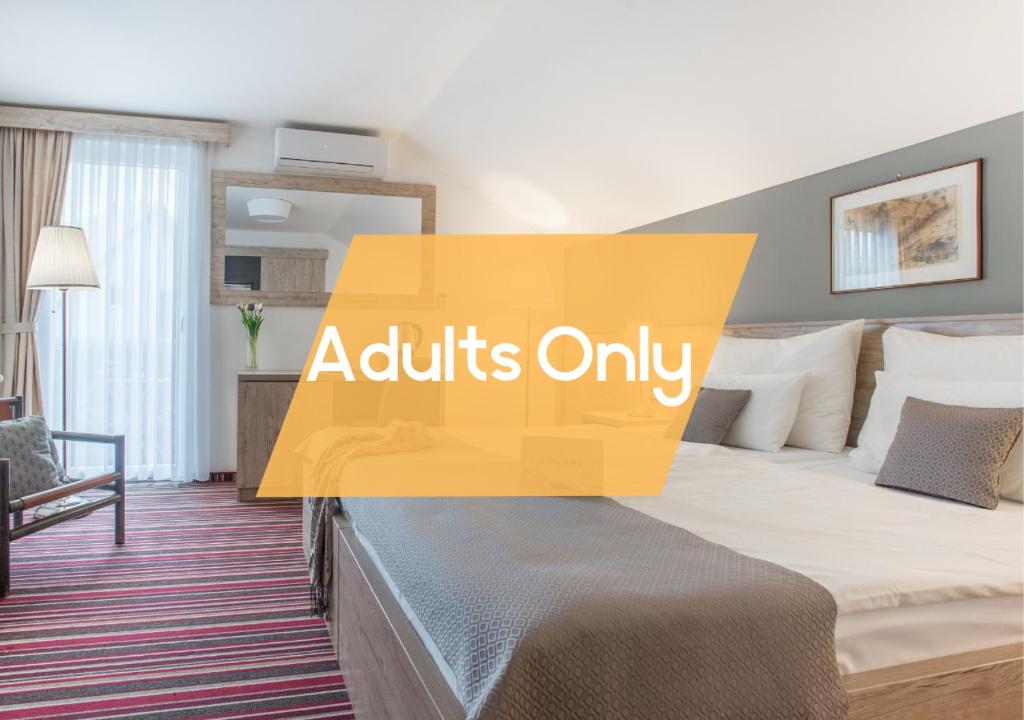 a hotel room with a bed with the words adults only at Boutique house Oreskovic in Plitvička Jezera