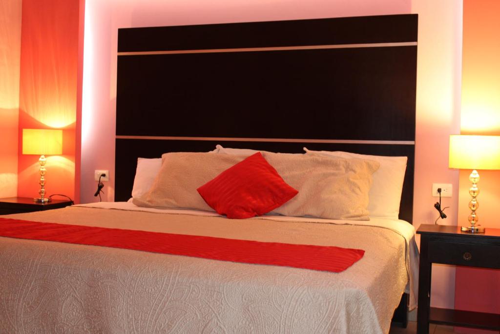 Postel nebo postele na pokoji v ubytování Hotel Boutique La Orquidea