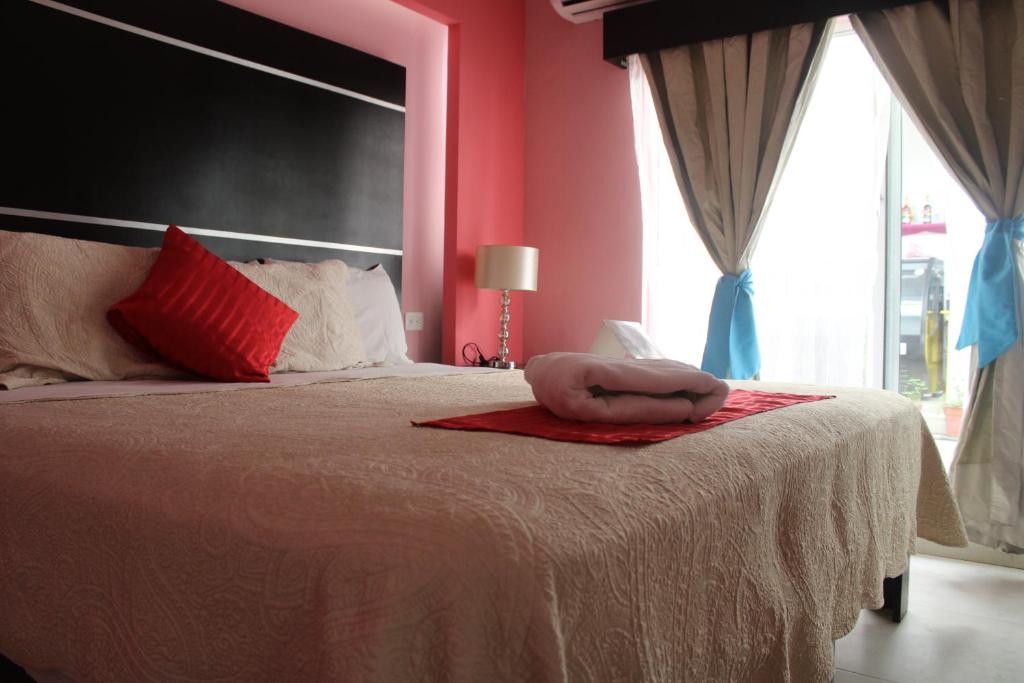 Postel nebo postele na pokoji v ubytování Hotel Boutique La Orquidea
