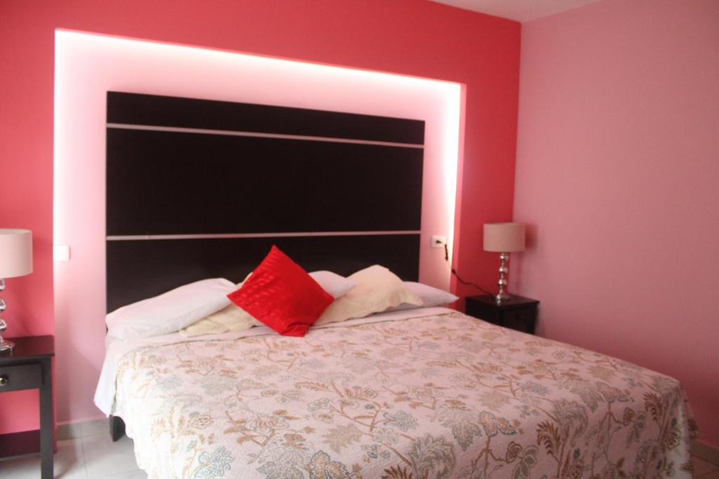 Postel nebo postele na pokoji v ubytování Hotel Boutique La Orquidea