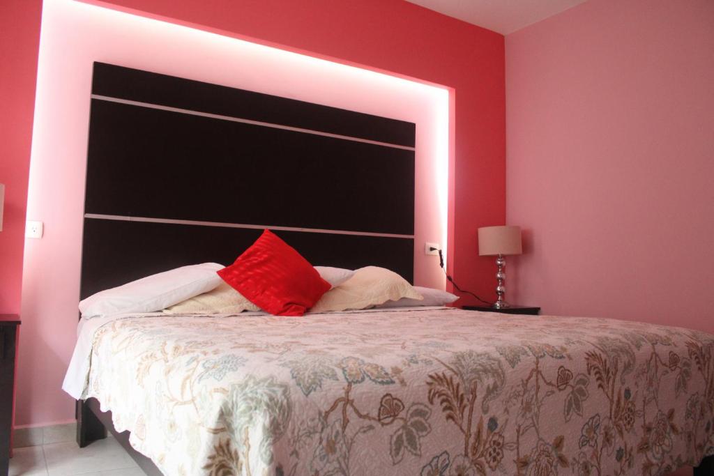 Postel nebo postele na pokoji v ubytování Hotel Boutique La Orquidea