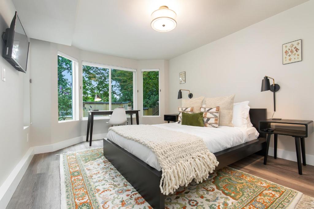 a bedroom with a large bed and a window at Madison Park Seattle with Outdoor Private Garden and Grill 1BR 1BA in Seattle