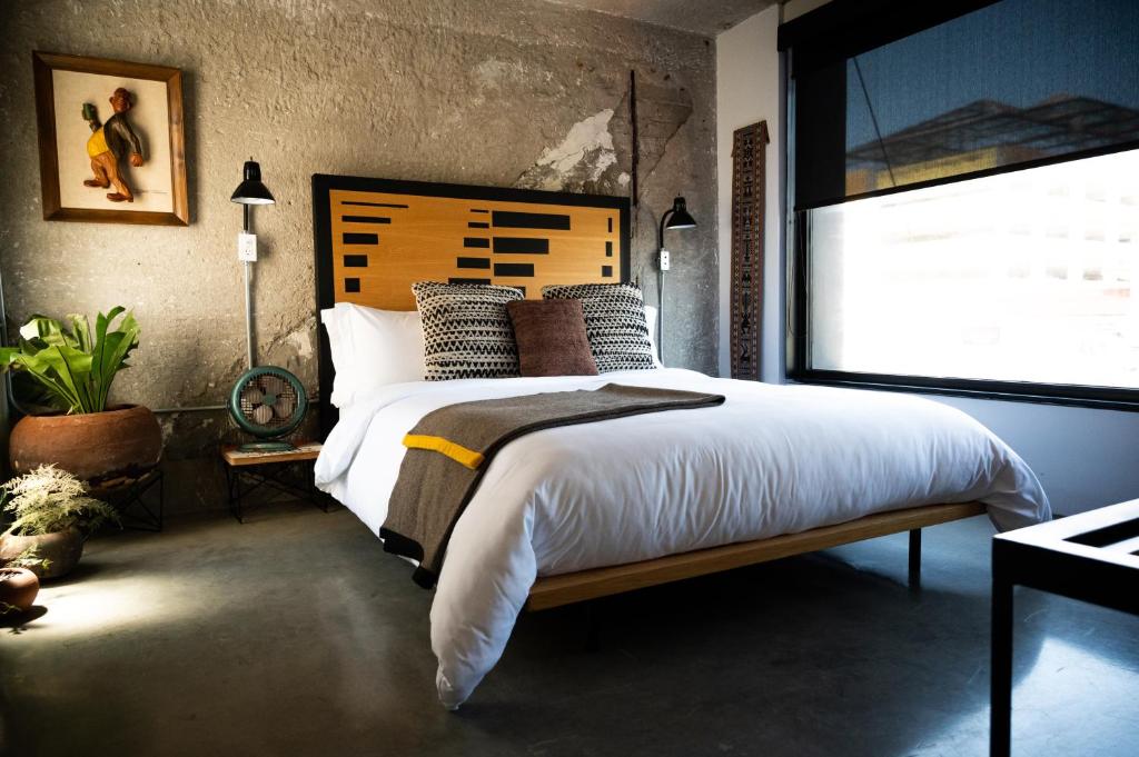Postel nebo postele na pokoji v ubytování Hotel Boutique Lafayette Tijuana