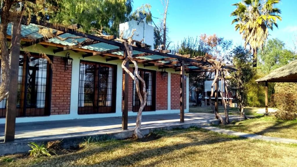 a house with a tree in the yard at Casa Quinta Rodeada de Bodegas Piscina BBQ Mendoza in Maipú