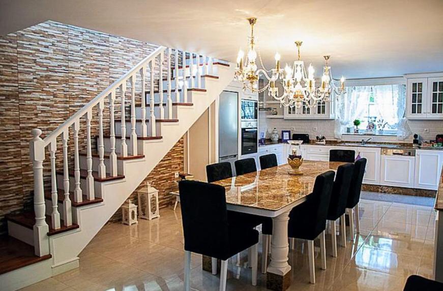 a kitchen and dining room with a table and stairs at Casa Pedro e Inês in Viana do Castelo