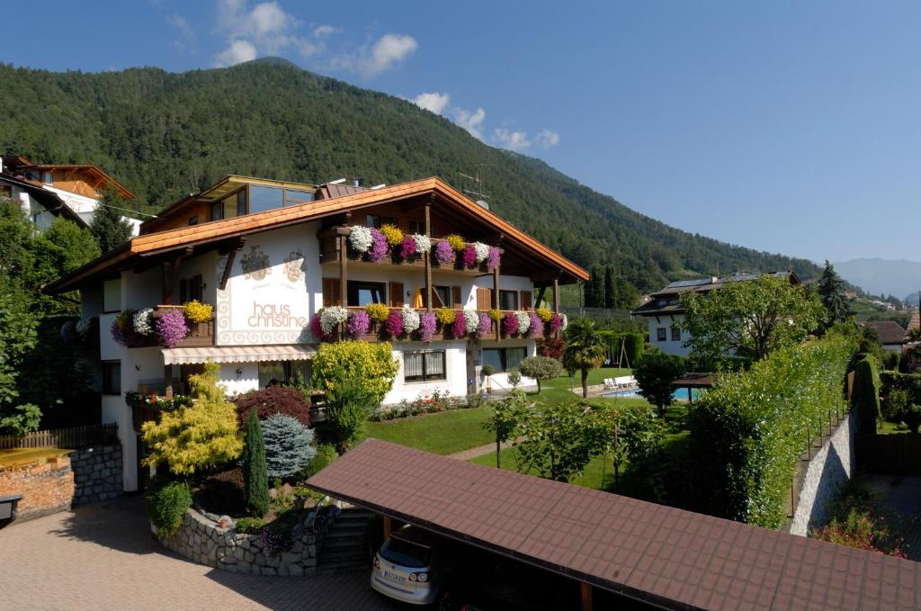 a building with flowers on the side of it at Ferienwohnungen Haus Christine in Rifiano